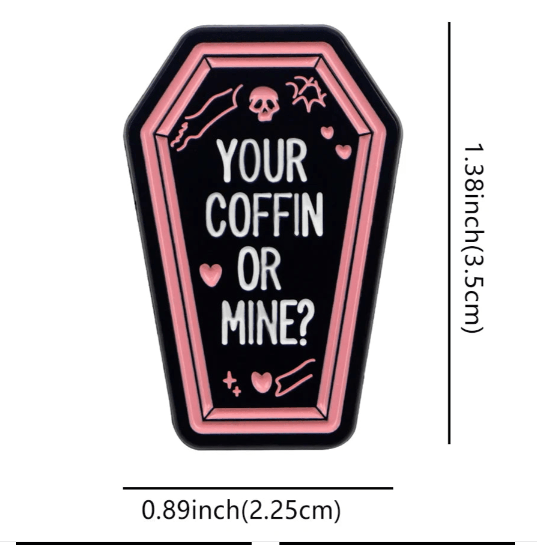 Kiss Me Later coffin badge with pink borders, white YOUR COFFIN OR MINE? text, small hearts, skull, and bone. Measures 1.38 x 0.89 (3.5 cm x 2.25 cm).