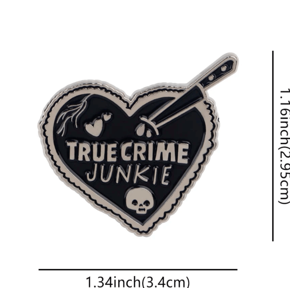 Kiss Me Later’s heart-shaped black enamel pin features TRUE CRIME JUNKIE in white, a knife, skull, blood drops, and a broken heart. Perfect for collectors of eerie coffin or skeleton badges. Measures 1.34 × 1.16 (3.4 cm × 2.95 cm).